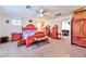 Main bedroom with wooden furniture, ceiling fan, and access to other rooms at 6046 Castle Gardens Ave, Las Vegas, NV 89130