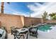 Private backyard oasis with pool and patio furniture at 6050 Belvedere Canyon Ave, Las Vegas, NV 89139