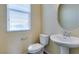 Clean bathroom with pedestal sink and window at 6050 Belvedere Canyon Ave, Las Vegas, NV 89139