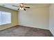 Simple carpeted bedroom with ceiling fan and window at 6050 Belvedere Canyon Ave, Las Vegas, NV 89139