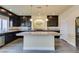 Modern kitchen with dark cabinetry, granite counters, and a large island at 6050 Belvedere Canyon Ave, Las Vegas, NV 89139