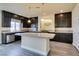 Modern kitchen with dark cabinetry, granite counters, and a large island at 6050 Belvedere Canyon Ave, Las Vegas, NV 89139