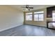 Spacious living room featuring gray vinyl plank flooring and ceiling fan at 6050 Belvedere Canyon Ave, Las Vegas, NV 89139