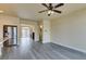 Open living room with hardwood floors and a view into the kitchen at 6050 Belvedere Canyon Ave, Las Vegas, NV 89139