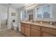 Bright bathroom featuring a double window, single sink vanity with granite countertop, and tile flooring at 628 L, Boulder City, NV 89005