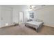 Bright bedroom with carpeted floor, a queen-size bed, and an ensuite bathroom at 628 L, Boulder City, NV 89005