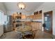 Well-lit kitchen featuring wooden cabinetry, stainless steel appliances, and a round breakfast table, creating a cozy cooking space at 628 L, Boulder City, NV 89005