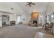 Bright living room with a stone fireplace, vaulted ceiling, and an open layout, perfect for entertaining guests at 628 L, Boulder City, NV 89005