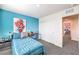 Bright bedroom with teal bedding and built-in workspace at 6546 Coffee Theme St # Lot 11, North Las Vegas, NV 89084