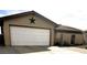 House exterior showcasing a white garage door and desert landscaping at 659 Glenwood Ln, Henderson, NV 89002