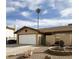 Single-story house with a white garage door and a landscaped front yard at 659 Glenwood Ln, Henderson, NV 89002