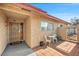 Small patio with table and chairs, adjacent to the front entrance at 659 Glenwood Ln, Henderson, NV 89002