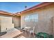 Small front patio with a table and chairs, next to the house at 659 Glenwood Ln, Henderson, NV 89002