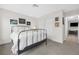 Spacious bedroom with a metal bed frame and access to a hallway at 6973 Emerald Springs Ln, Las Vegas, NV 89113