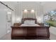 Well-lit bedroom with a wood accent wall and sliding glass doors at 6973 Emerald Springs Ln, Las Vegas, NV 89113