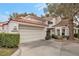 Exterior of beautiful home with tile roof and landscaping at 6973 Emerald Springs Ln, Las Vegas, NV 89113