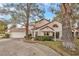 Two-story house with Spanish tile roof, attached garage, and landscaped yard at 6973 Emerald Springs Ln, Las Vegas, NV 89113