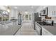 Modern kitchen with stainless steel appliances and gray countertops at 6973 Emerald Springs Ln, Las Vegas, NV 89113