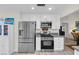 Modern kitchen with stainless steel appliances and gray countertops at 6973 Emerald Springs Ln, Las Vegas, NV 89113