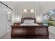 Main bedroom with wood-paneled accent wall and sliding door to patio at 6973 Emerald Springs Ln, Las Vegas, NV 89113