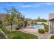 Landscaped backyard with a relaxing pool and lush greenery at 7 Summit Walk Trl, Henderson, NV 89052