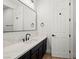 Modern bathroom with quartz countertop and dark cabinetry at 7 Summit Walk Trl, Henderson, NV 89052