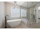 Luxurious bathroom with a soaking tub, walk-in shower, and modern finishes at 7 Summit Walk Trl, Henderson, NV 89052