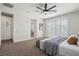 Serene bedroom with a cozy bed, access to a bathroom, and large windows at 7 Summit Walk Trl, Henderson, NV 89052