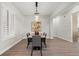 Modern dining room with wood table and statement art at 7 Summit Walk Trl, Henderson, NV 89052