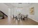 Elegant dining room with a long wooden table and chandelier at 7 Summit Walk Trl, Henderson, NV 89052