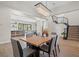 Bright dining room with a wooden table, chandelier, and view of the kitchen at 7 Summit Walk Trl, Henderson, NV 89052