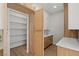 Walk-in kitchen pantry with open shelving and light wood cabinetry at 7 Summit Walk Trl, Henderson, NV 89052