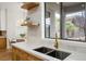 Modern kitchen sink with gold faucet and white quartz countertops at 7 Summit Walk Trl, Henderson, NV 89052