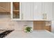 Kitchen detail showcasing white shaker cabinets with gold hardware and quartz countertops at 7 Summit Walk Trl, Henderson, NV 89052