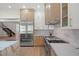 Stainless steel refrigerator and light wood cabinetry with marble countertops at 7 Summit Walk Trl, Henderson, NV 89052