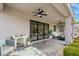 Relaxing covered patio with seating area, tile flooring, and ceiling fan at 7 Summit Walk Trl, Henderson, NV 89052