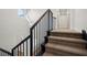 Modern staircase with metal railing and neutral carpet at 7 Summit Walk Trl, Henderson, NV 89052