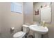 Small bathroom with pedestal sink and toilet at 7141 Liberty Landing St, Las Vegas, NV 89166