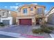 Two-story house with red door and garage at 7141 Liberty Landing St, Las Vegas, NV 89166