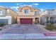 Two-story house with red door and garage at 7141 Liberty Landing St, Las Vegas, NV 89166