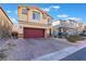 Two-story house with red door and garage at 7141 Liberty Landing St, Las Vegas, NV 89166