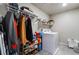 Laundry room with washer, dryer, and ample storage shelving at 7141 Liberty Landing St, Las Vegas, NV 89166