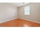 Light and airy bedroom with wood floors and window at 7322 Fools Gold St # 101, Las Vegas, NV 89149