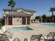 Community pool and spa with lounge chairs at 7322 Fools Gold St # 101, Las Vegas, NV 89149