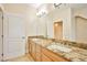 Double vanity bathroom with granite countertops and neutral cabinets at 768 Tozzetti Ln, Henderson, NV 89012