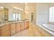 Elegant bathroom with granite countertops, soaking tub, and walk-in shower at 768 Tozzetti Ln, Henderson, NV 89012