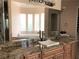 Bathroom with granite countertops, double sinks, and a large mirror reflecting a soaking tub at 768 Tozzetti Ln, Henderson, NV 89012