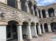 Elegant courtyard with stone columns, arched walkways, and a pool at 768 Tozzetti Ln, Henderson, NV 89012