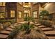 Grand entry with stone details and lush landscaping at 768 Tozzetti Ln, Henderson, NV 89012