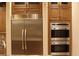 High-end stainless steel appliances including a double oven and refrigerator at 768 Tozzetti Ln, Henderson, NV 89012